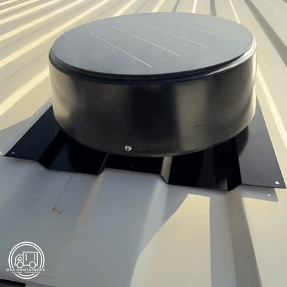 Black 10W solar-powered roof vent installed on corrugated metal shipping container roof panel.