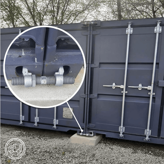 Steel bridge fittings securely connecting two shipping containers side-by-side for transport and stability.