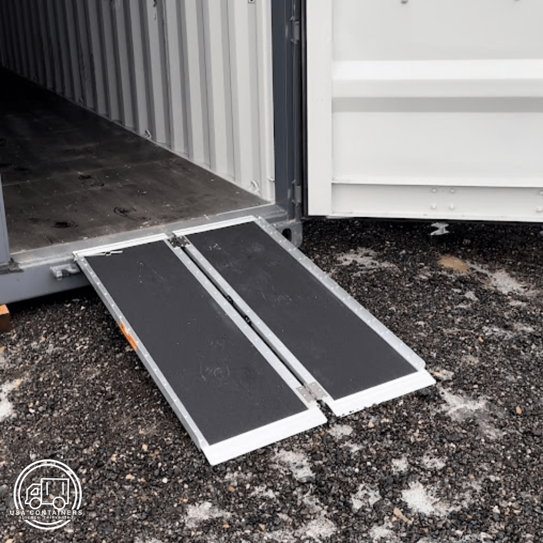 Foldable shipping container ramp with anti-slip surface for safe loading and unloading on rough ground.