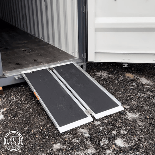 Foldable shipping container ramp with anti-slip surface for safe loading and unloading on rough ground.