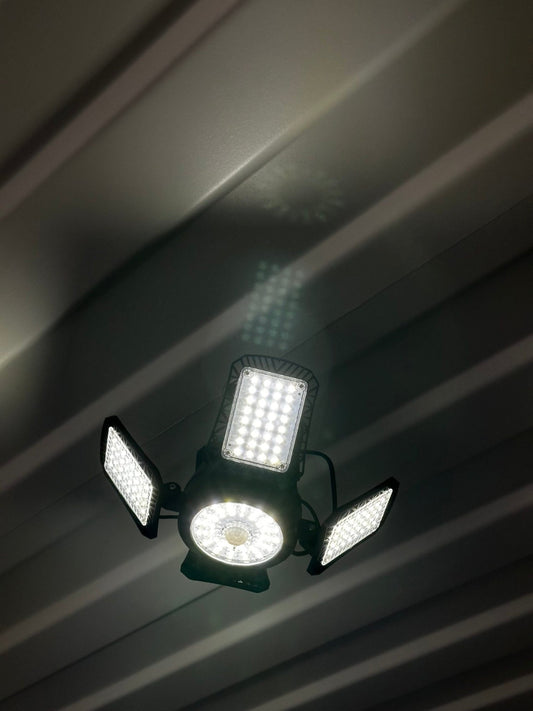 Bright solar shop light for lighting a shipping container interior, angle view