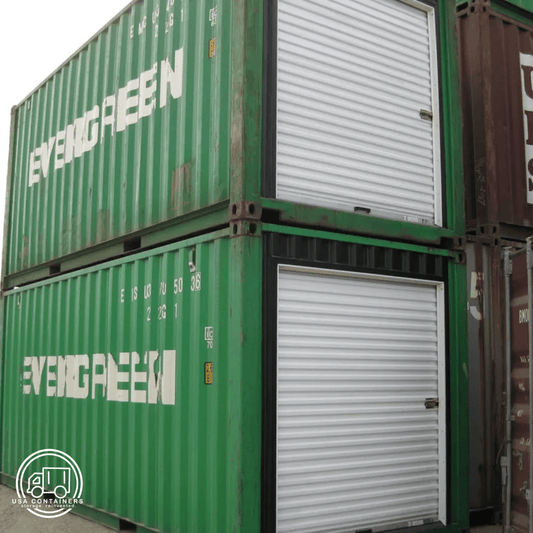 Green shipping containers with white roll up doors installed on the side for easy access and durability.