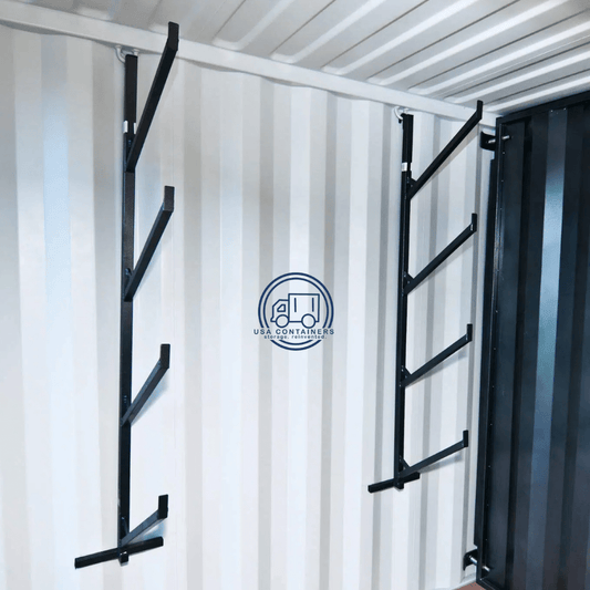 Pair of black shipping container shelving brackets installed on container walls for heavy-duty pipe rack storage.