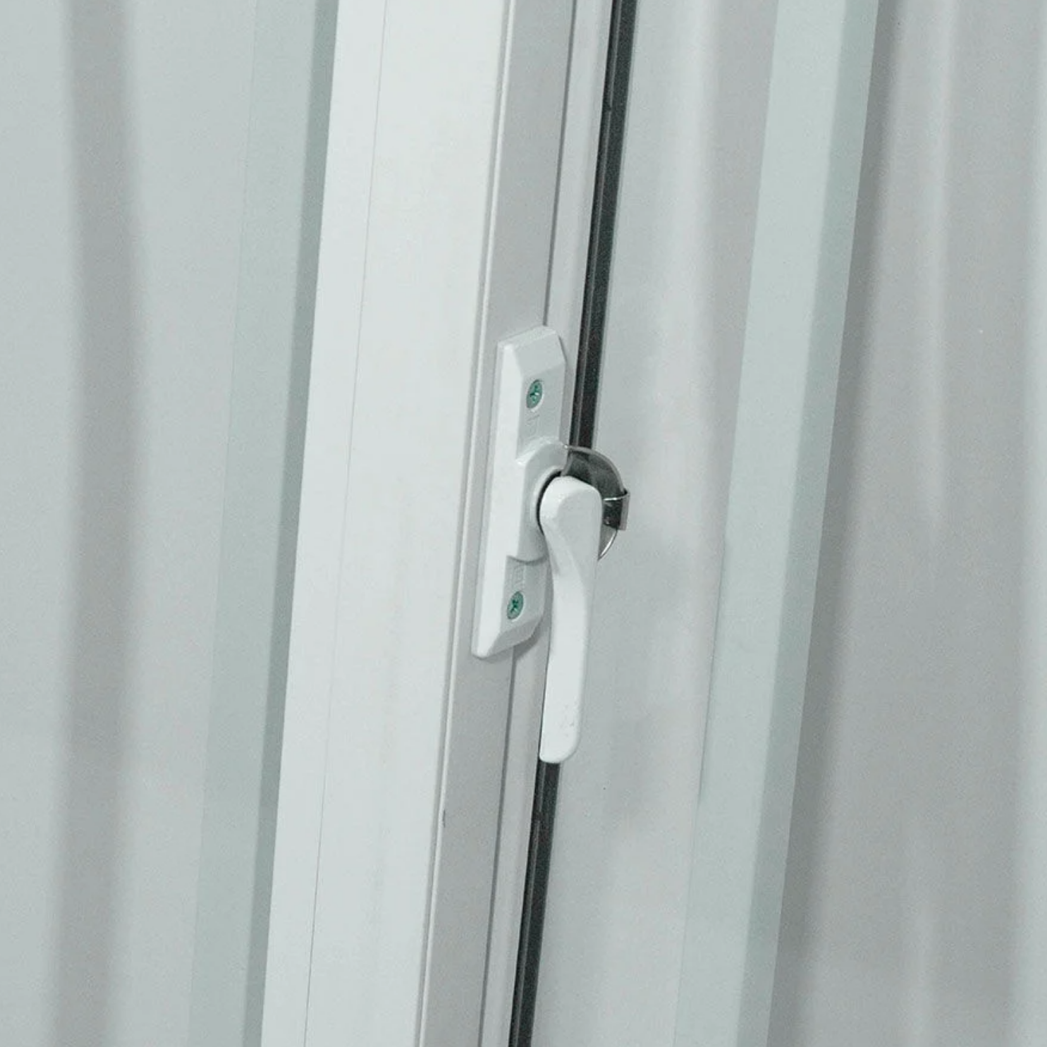 Close-up of the locking handle on a secured shipping container window