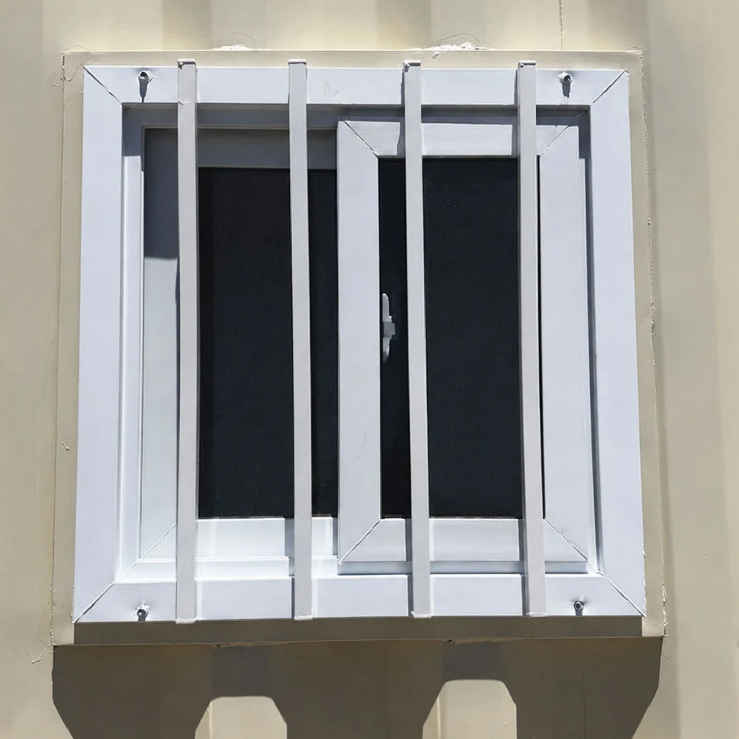Secured shipping container windows with steel security bars installed in a container wall